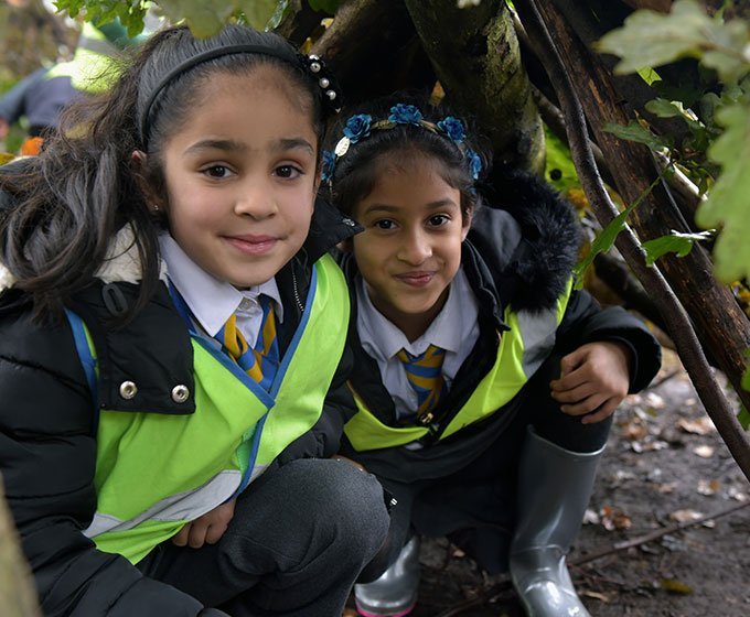 girls hiding in den on a stone age day