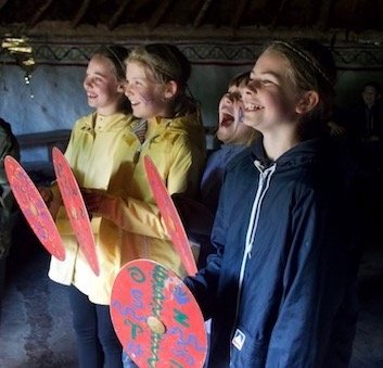 Smiling girls with shields